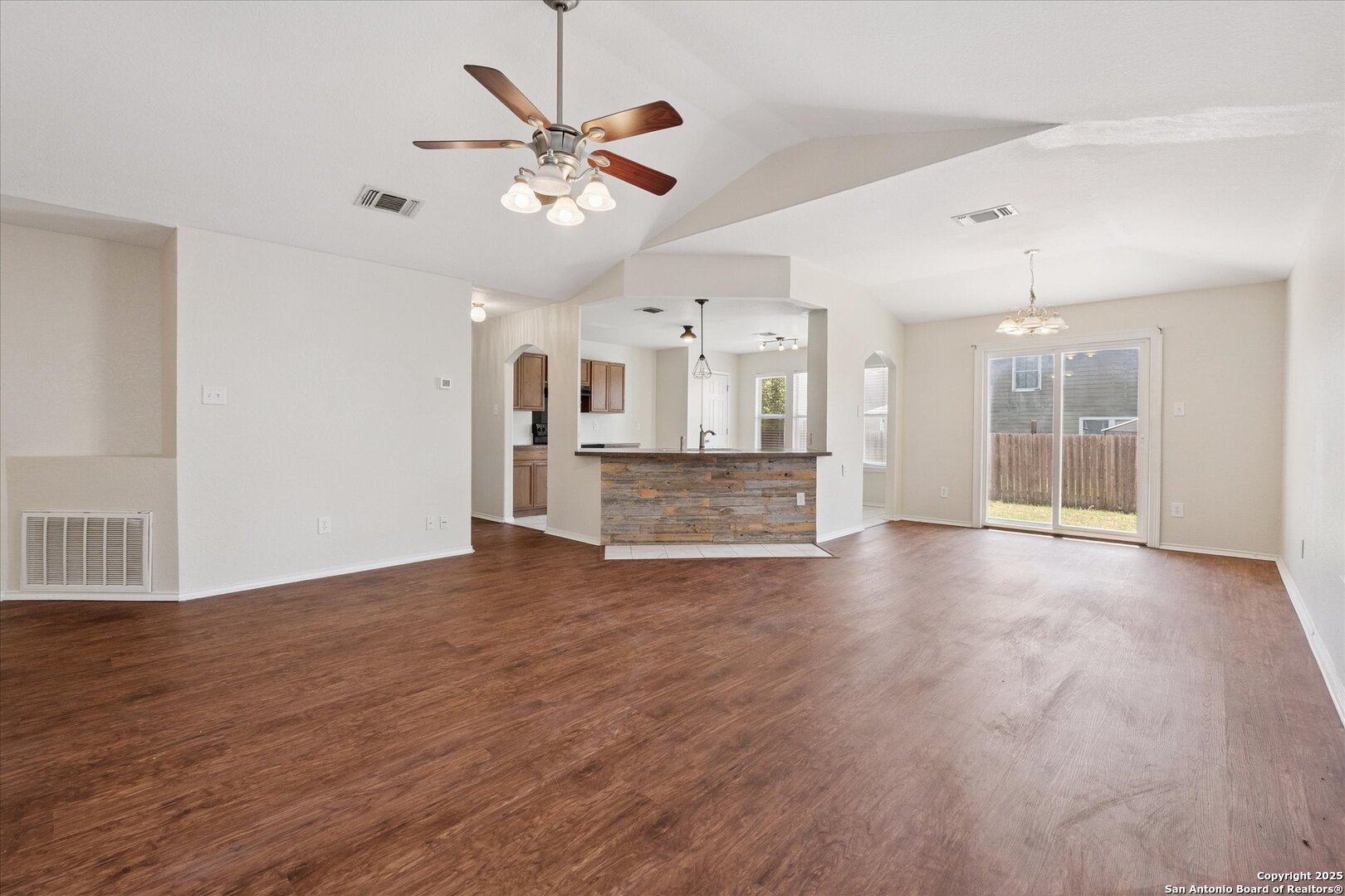 3436 Whisper Bluff Cibolo, TX 78108 - Photo 10 of 34 a view of a big room with wooden floor and a ceiling fan