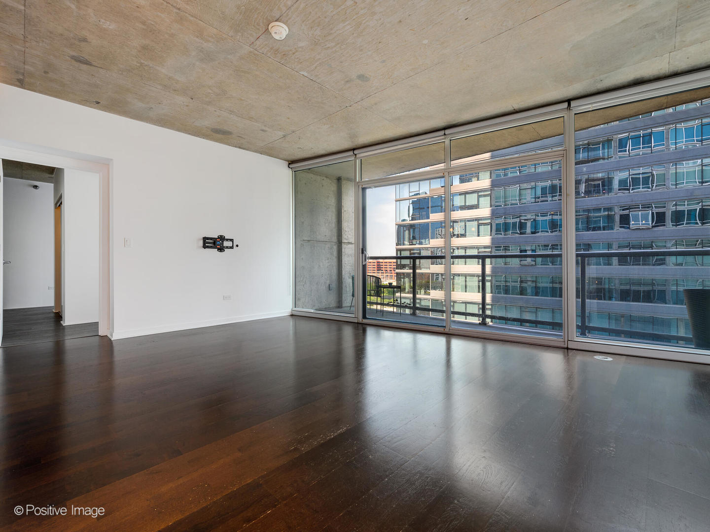 611 South Wells Street, Unit 906 Chicago, IL 60607 - Photo 11 of 21 a view of empty room with wooden floor and floor to ceiling window