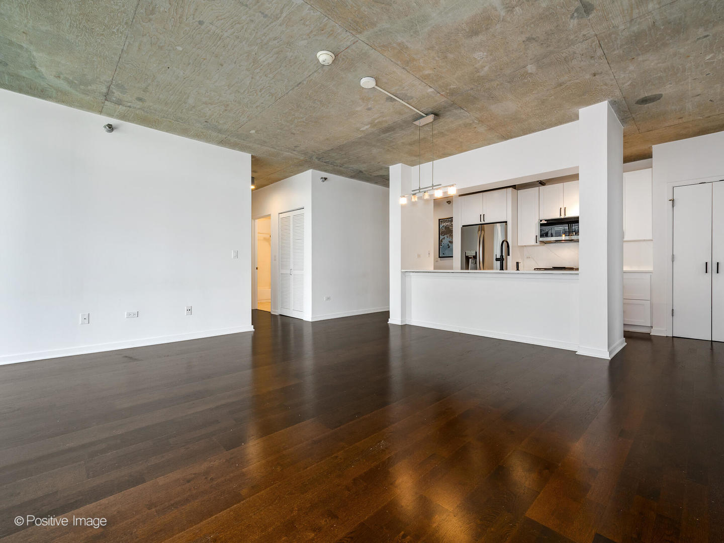 611 South Wells Street, Unit 906 Chicago, IL 60607 - Photo 12 of 21 a view of a kitchen with wooden floor and kitchen appliances