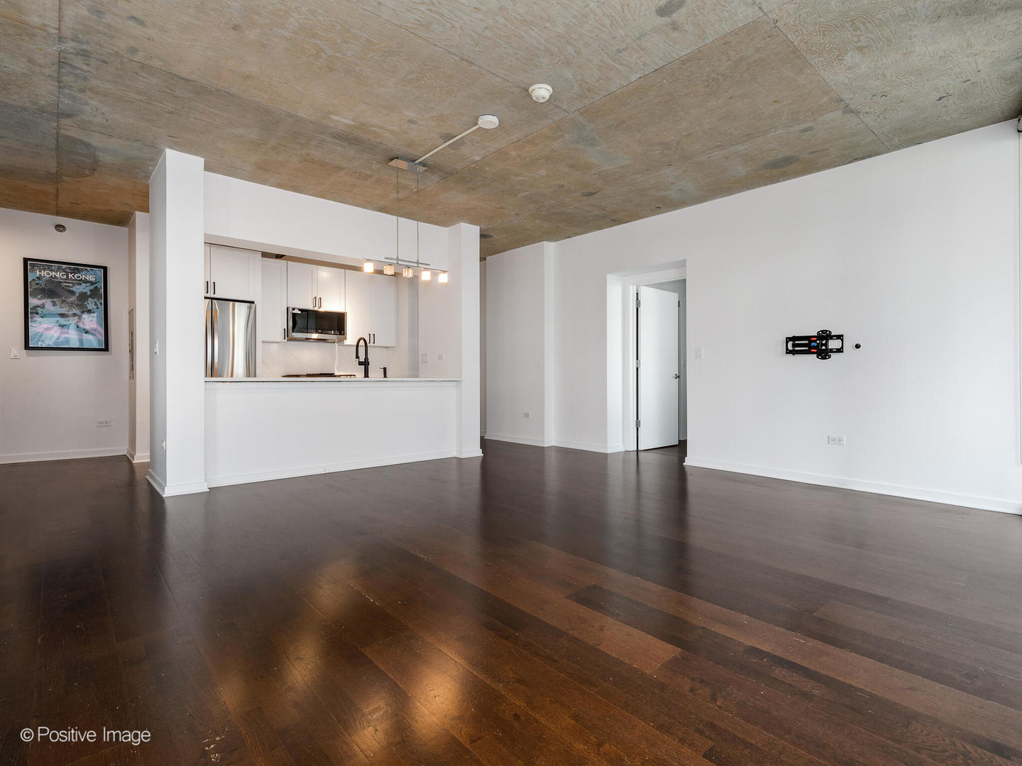 611 South Wells Street, Unit 906 Chicago, IL 60607 - Photo 13 of 21 a view of a kitchen with wooden floor and a kitchen
