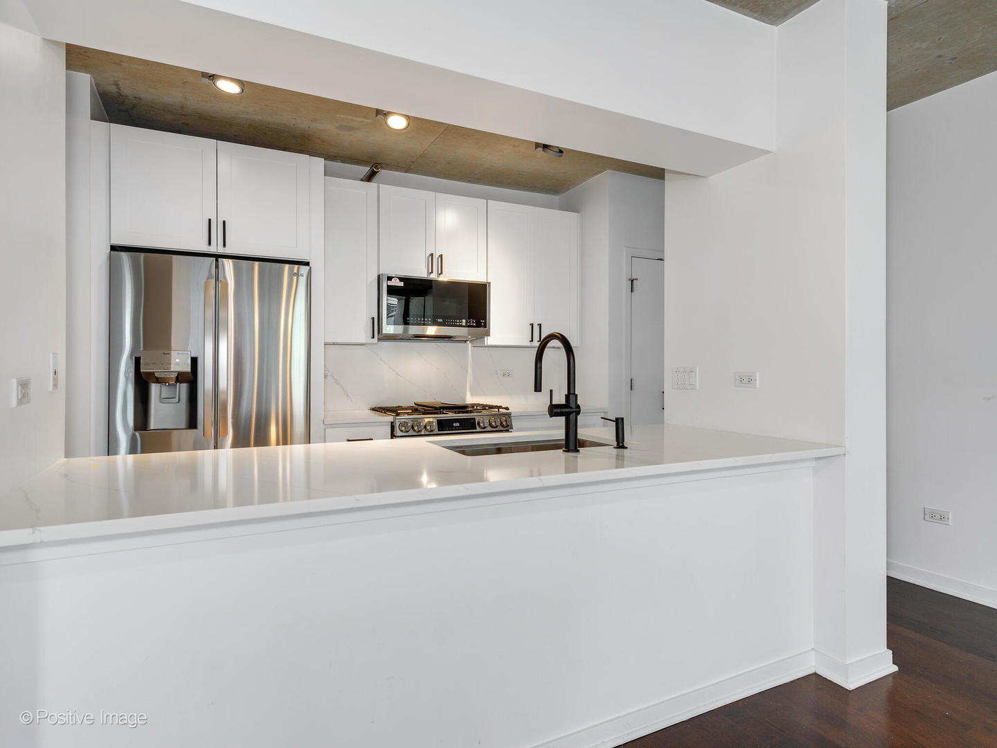 611 South Wells Street, Unit 906 Chicago, IL 60607 - Photo 14 of 21 a kitchen with stainless steel appliances a sink stove and refrigerator