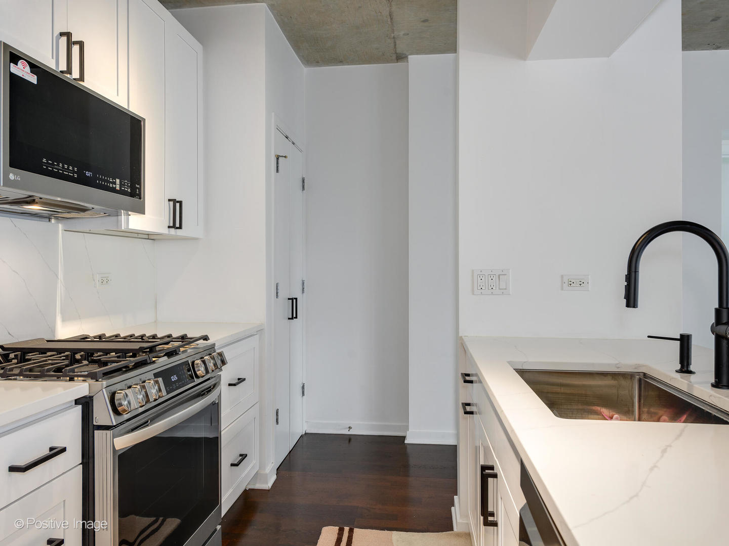 611 South Wells Street, Unit 906 Chicago, IL 60607 - Photo 16 of 21 a kitchen with a stove and a microwave