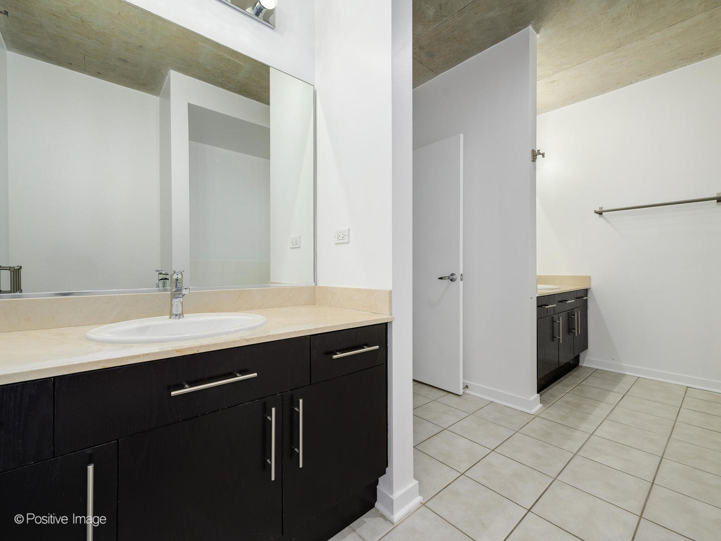 611 South Wells Street, Unit 906 Chicago, IL 60607 - Photo 18 of 21 a bathroom with a double vanity sink and mirror