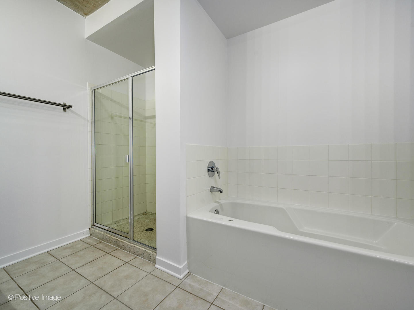 611 South Wells Street, Unit 906 Chicago, IL 60607 - Photo 19 of 21 a spacious bathroom with a bathtub and a shower