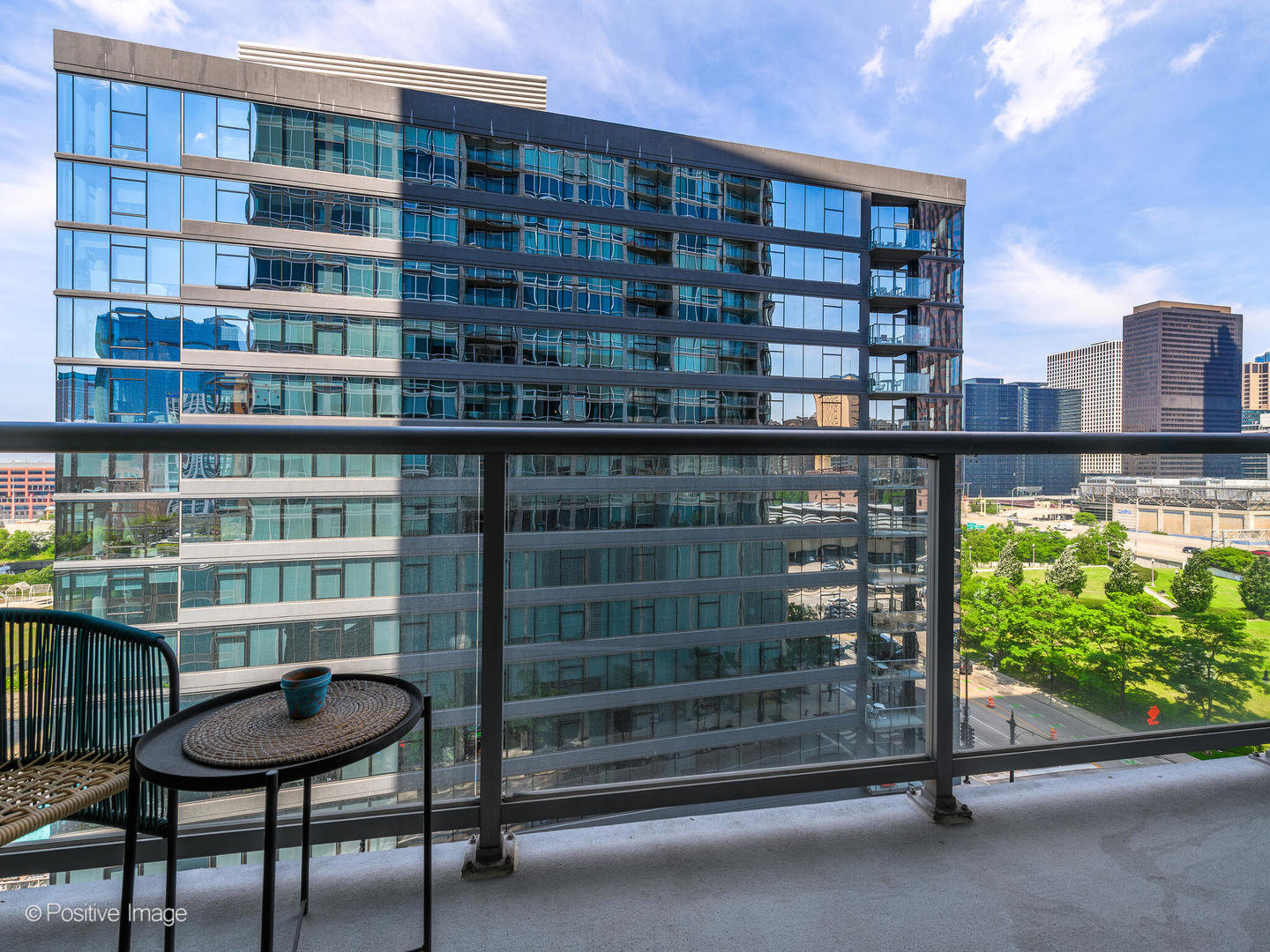 611 South Wells Street, Unit 906 Chicago, IL 60607 - Photo 2 of 21 a picture of a table and chairs in a balcony