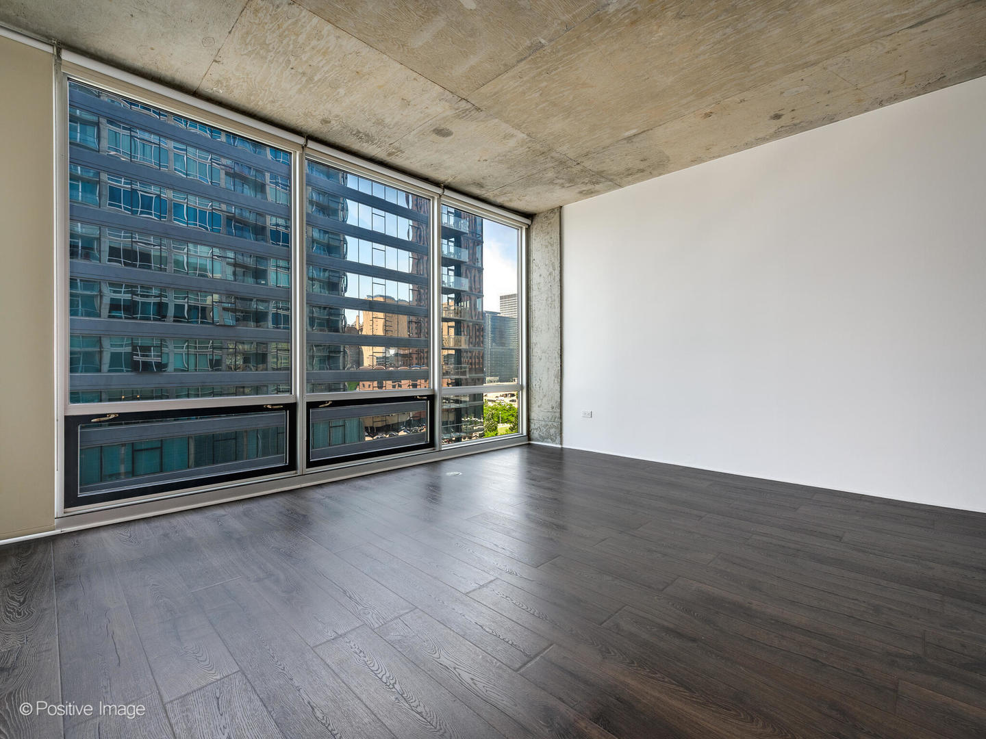 611 South Wells Street, Unit 906 Chicago, IL 60607 - Photo 9 of 21 a view of an empty room with wooden floor