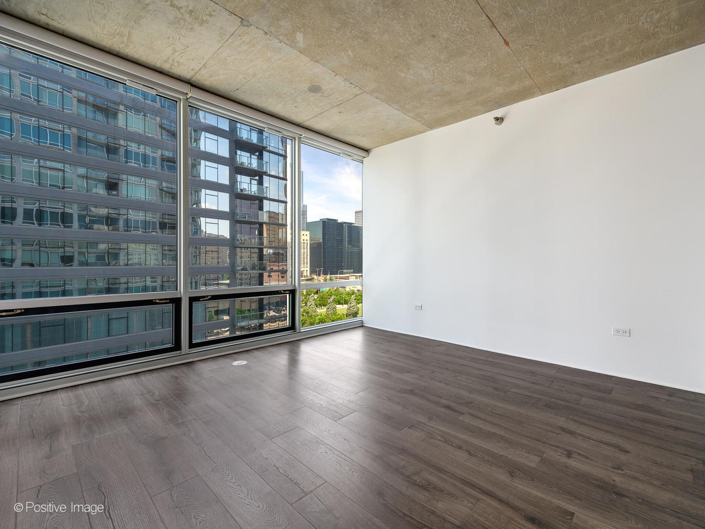 611 South Wells Street, Unit 906 Chicago, IL 60607 - Photo 10 of 21 a view of an empty room with wooden floor