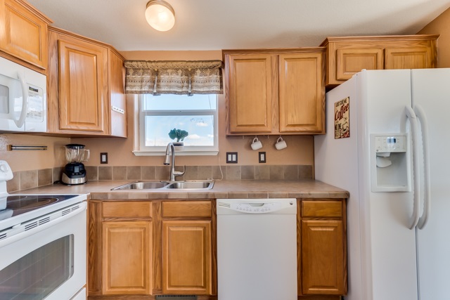 2227 H Road Grand Junction, CO 81505 - Photo 23 of 32 a kitchen with stainless steel appliances granite countertop a sink stove and refrigerator