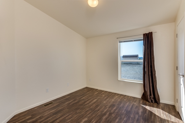 2227 H Road Grand Junction, CO 81505 - Photo 25 of 32 an empty room with wooden floor and windows