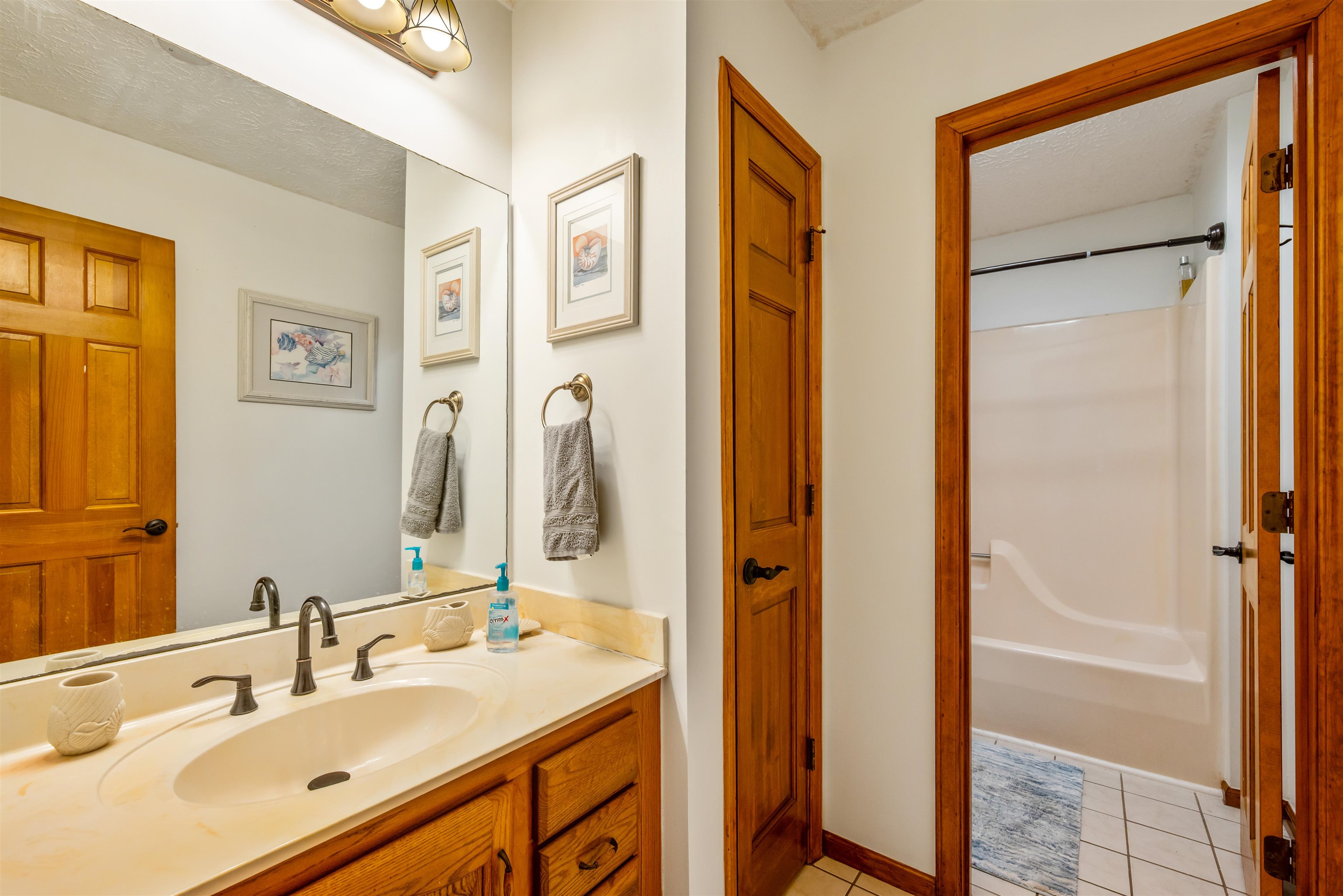 4746 National Drive Myrtle Beach, SC 29579 - Photo 27 of 40 Full bath featuring vanity, light tile patterned flooring, bathing tub / shower combination, and a textured ceiling