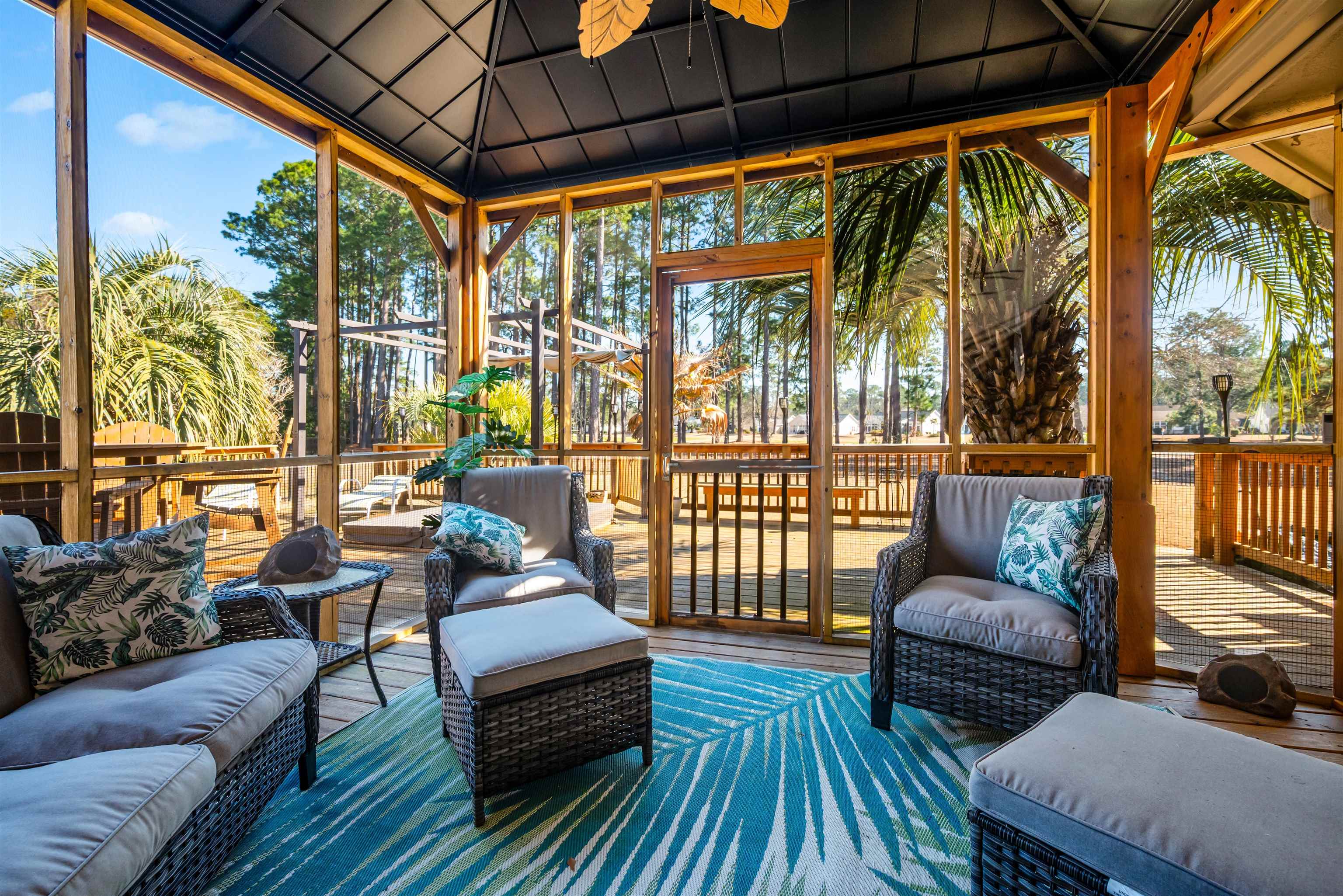 4746 National Drive Myrtle Beach, SC 29579 - Photo 34 of 40 Sunroom with an outdoor living space, ceiling fan, a wooden deck, and vaulted ceiling