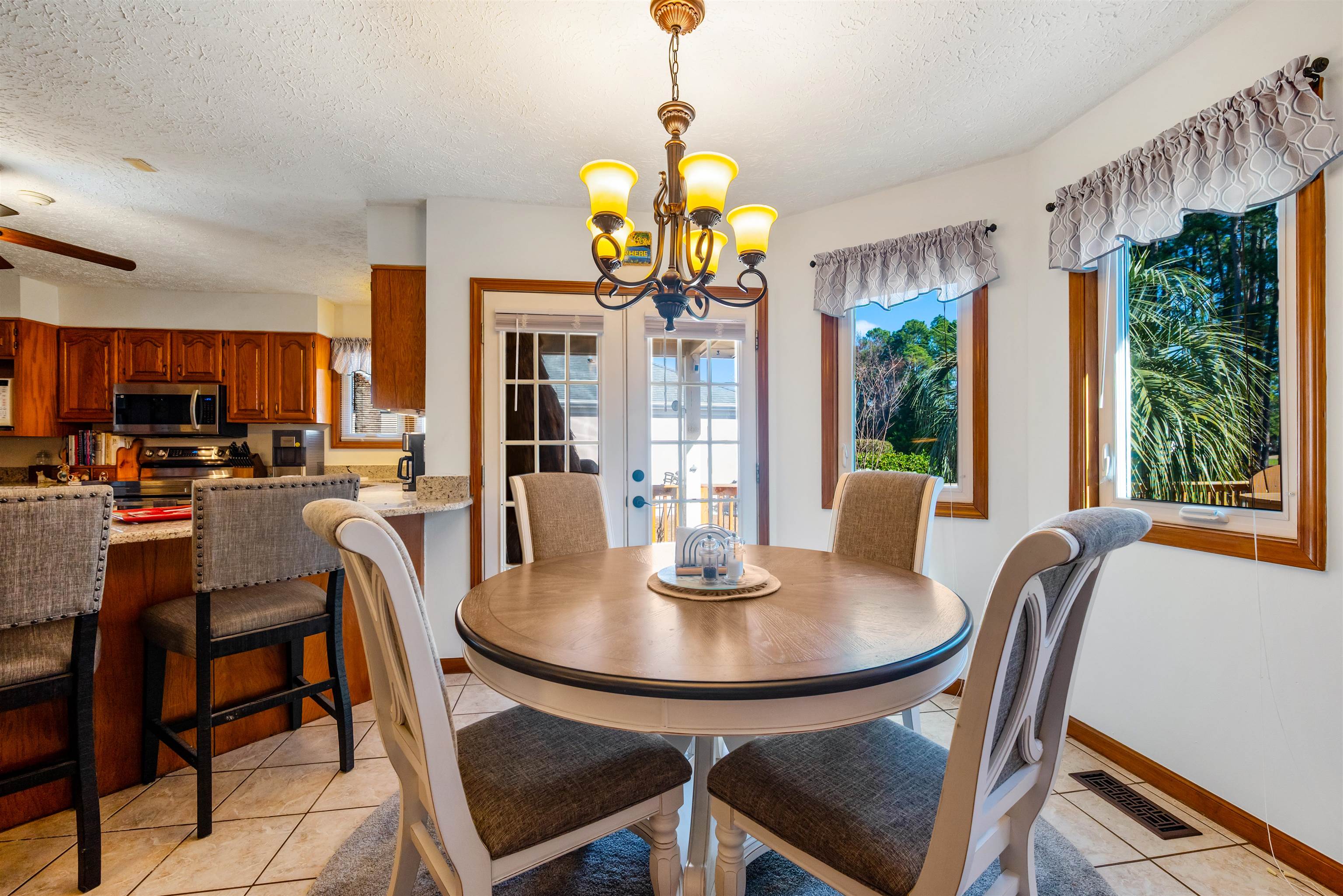 4746 National Drive Myrtle Beach, SC 29579 - Photo 8 of 40 Dining space with french doors, light tile patterned flooring, a textured ceiling, and a chandelier