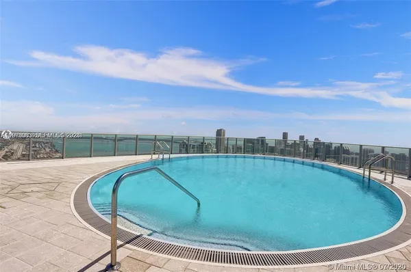 a view of a swimming pool with a yard