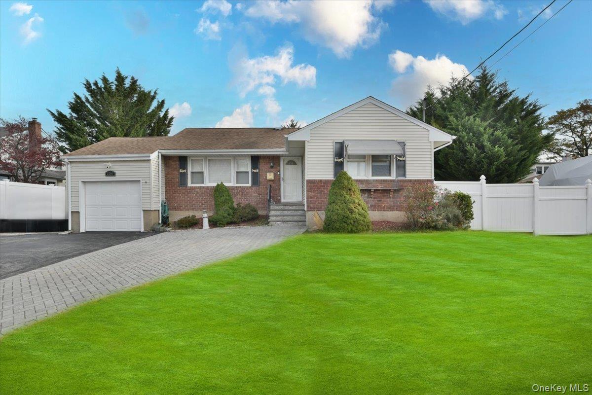 a front view of a house with a garden and yard