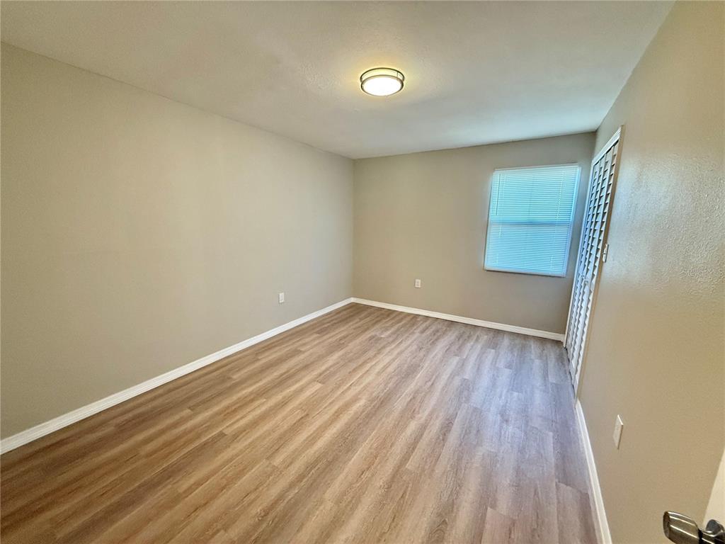 2769 L B McLeod Road, Unit 2769A Orlando, FL 32805 - Photo 11 of 15 a view of room with wooden floor