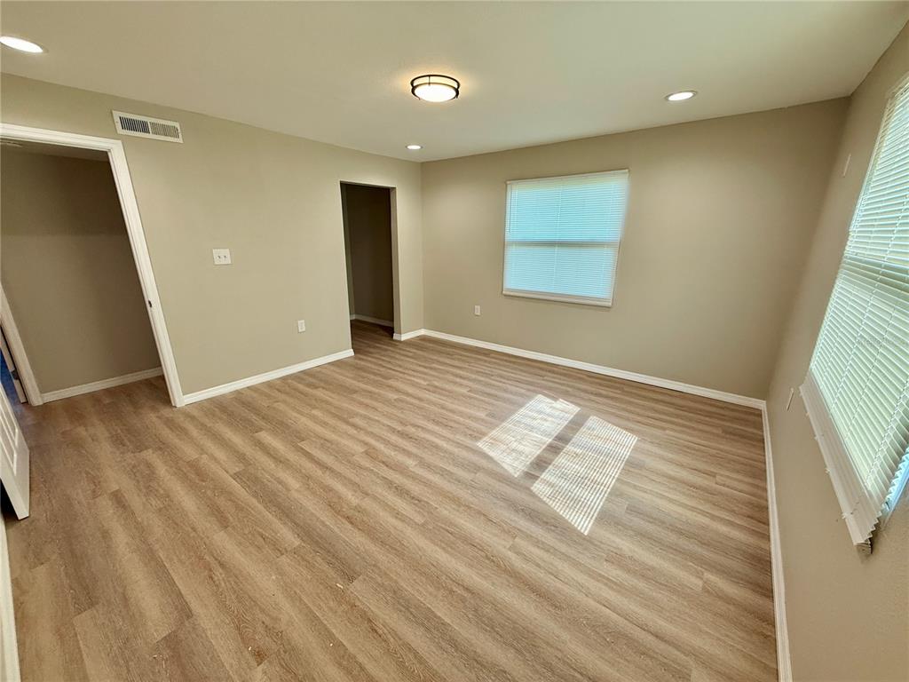 2769 L B McLeod Road, Unit 2769A Orlando, FL 32805 - Photo 13 of 15 a view of empty room with wooden floor
