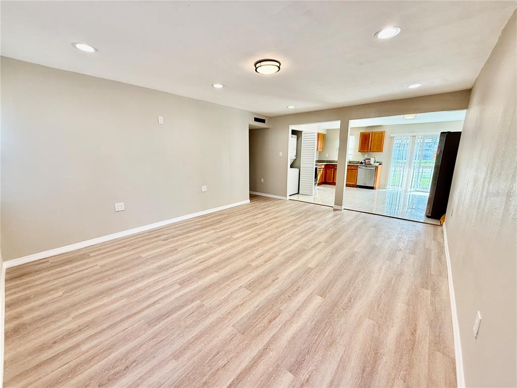 2769 L B McLeod Road, Unit 2769A Orlando, FL 32805 - Photo 3 of 15 wooden floor in an empty room with a window