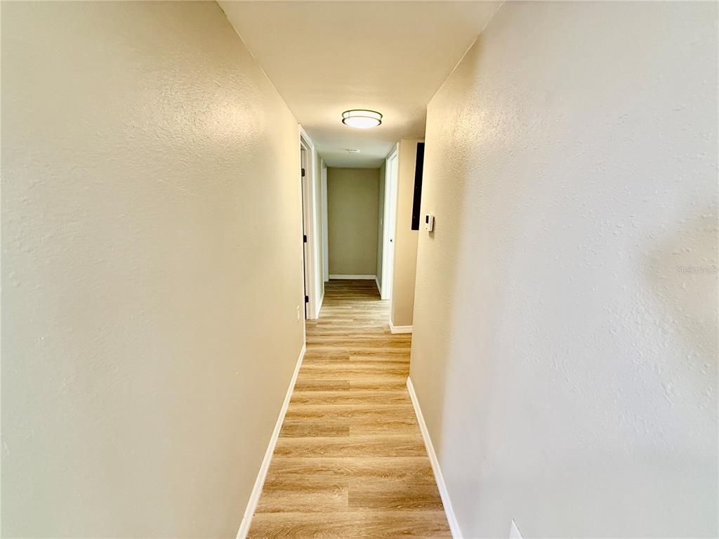 2769 L B McLeod Road, Unit 2769A Orlando, FL 32805 - Photo 9 of 15 a view of a hallway with wooden floor