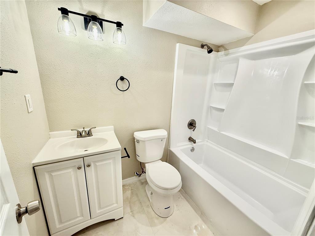 2769 L B McLeod Road, Unit 2769A Orlando, FL 32805 - Photo 10 of 15 a bathroom with a toilet a sink and a bathtub