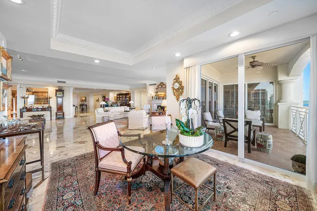 a balcony with outdoor seating and city view