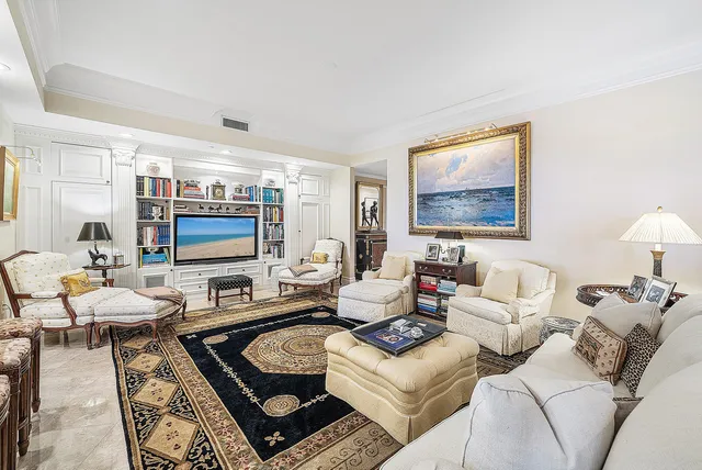 a spacious bedroom with a bed a couch and a large window