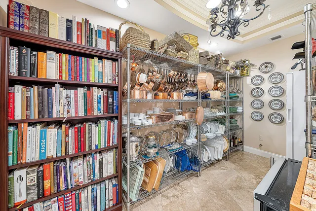 a living room with furniture a floor to ceiling window and a flat screen tv
