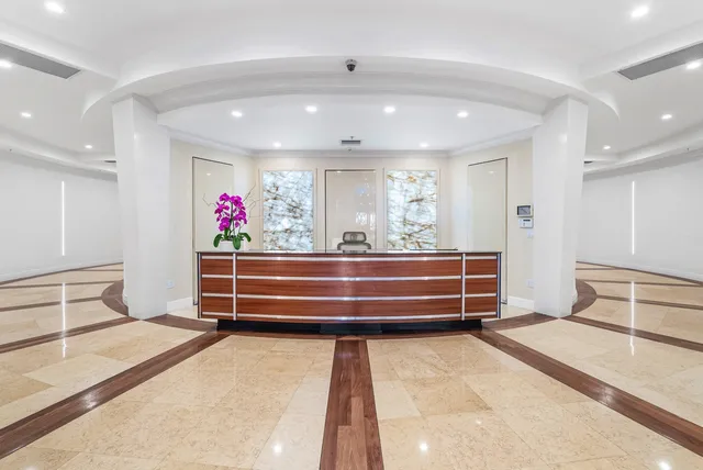 a room with furniture and view of kitchen