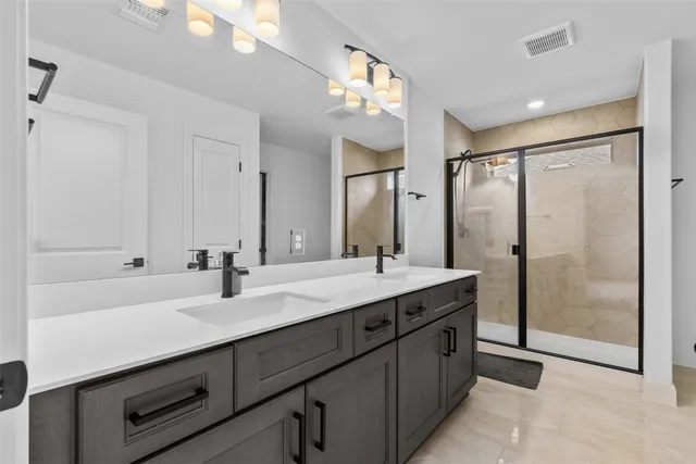 a bathroom with a double vanity sink mirror and double