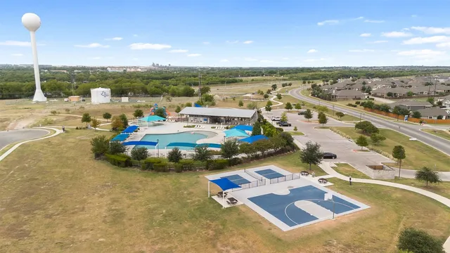 an aerial view of a house with outdoor space and lake view