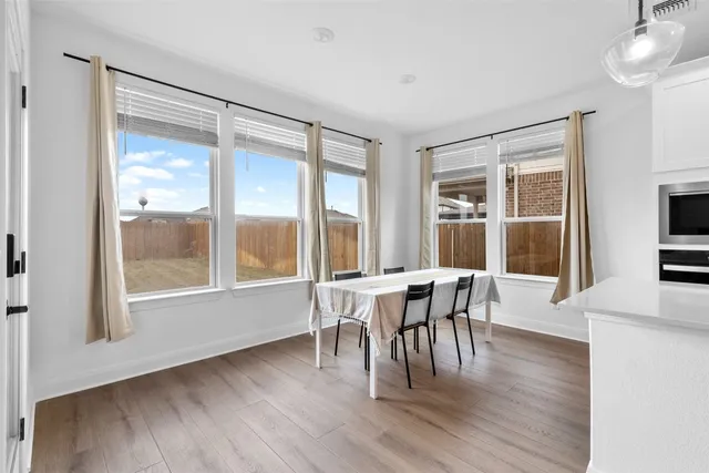 a dining room with furniture window wooden floor