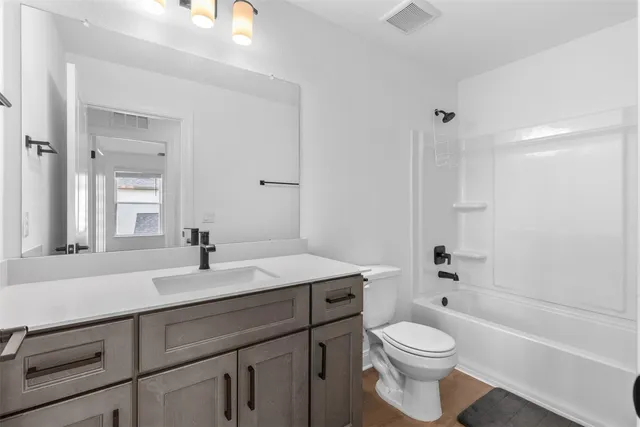 a bathroom with a sink a toilet and a bathtub