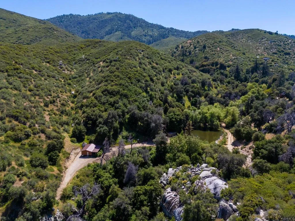 63 San Felipe Road Warner Springs, CA 92086 - Photo 3 of 43 a view of a lush green hillside and a building