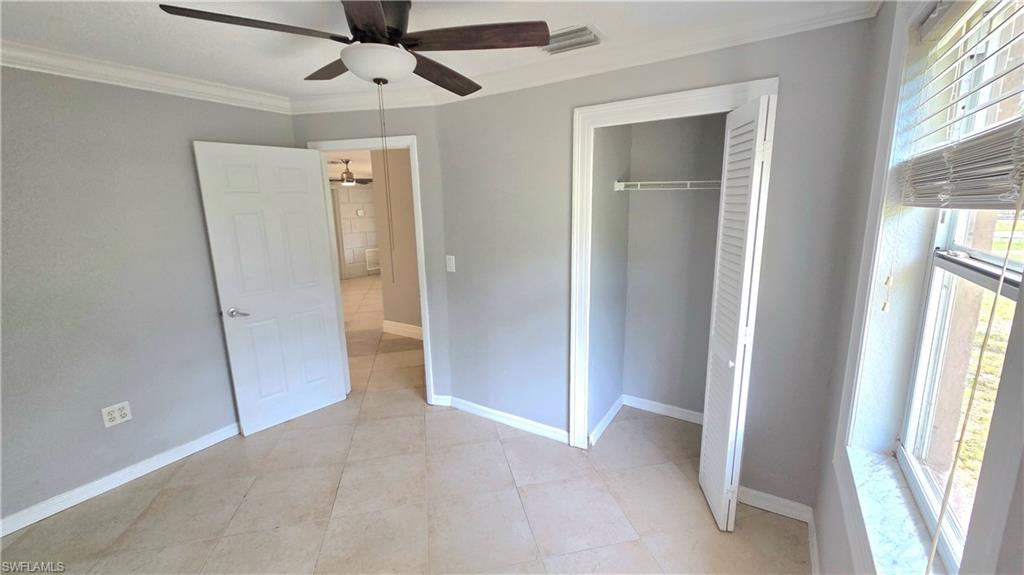 5529 Hardee Street Naples, FL 34113 - Photo 10 of 17 Bedroom #2 featuring tile flooring, a ceiling fan with light fixture, and a window with horizontal blinds