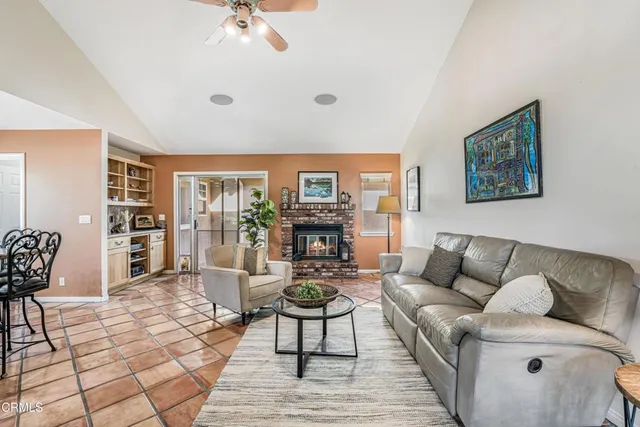 a kitchen with stainless steel appliances kitchen island granite countertop a table chairs and a refrigerator