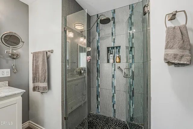 a bedroom with a bed and a refrigerator