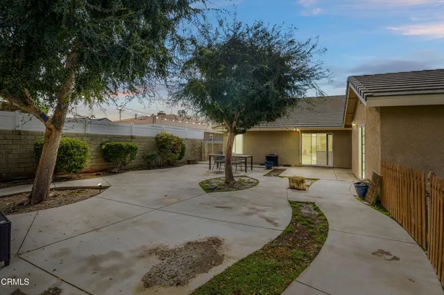 a view of a patio with table and chairs and potted plants