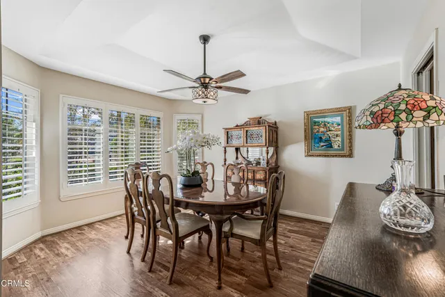 a living room with furniture a flat screen tv and kitchen view