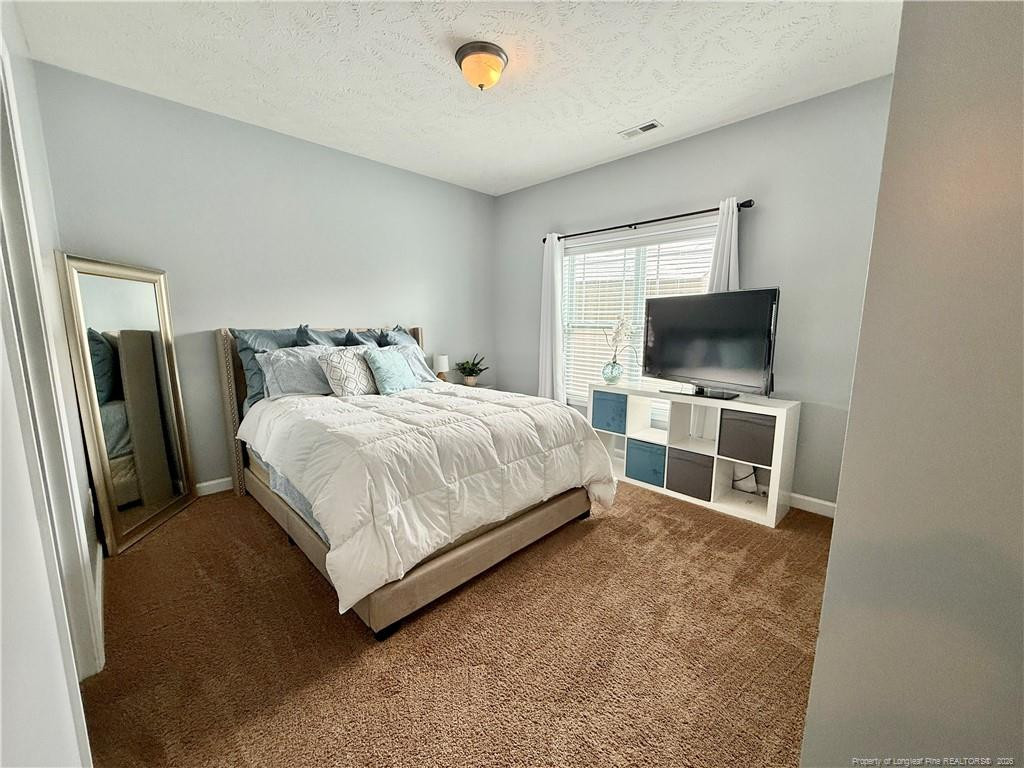 35 Ambrose Point Cameron, NC 28326 - Photo 13 of 31 a bedroom with a bed and a flat screen tv