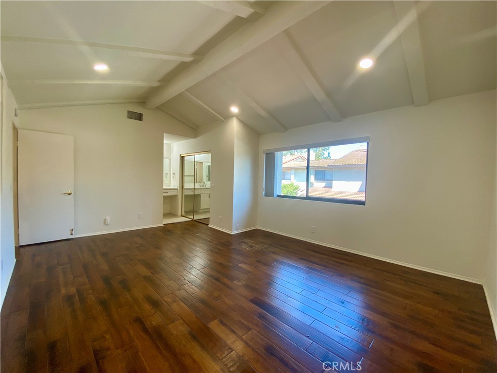 809 Creekside Drive, Unit 35 Fullerton, CA 92833 - Photo 15 of 23 a view of an empty room with wooden floor and a window