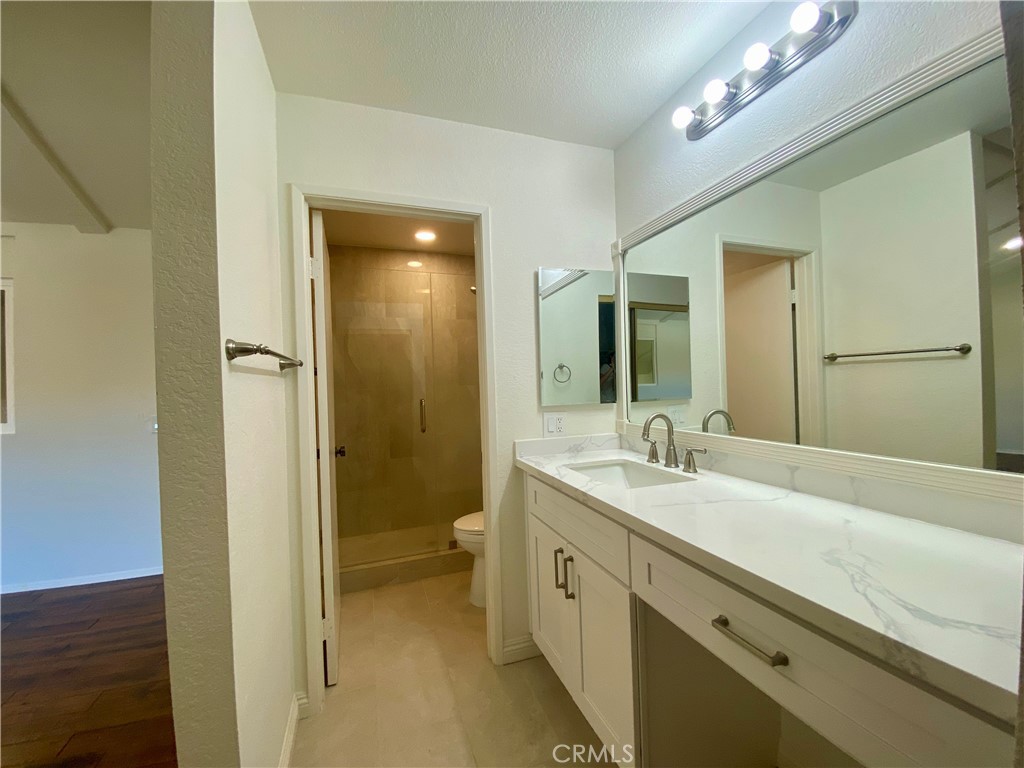 809 Creekside Drive, Unit 35 Fullerton, CA 92833 - Photo 16 of 23 a bathroom with a sink a toilet and a large mirror