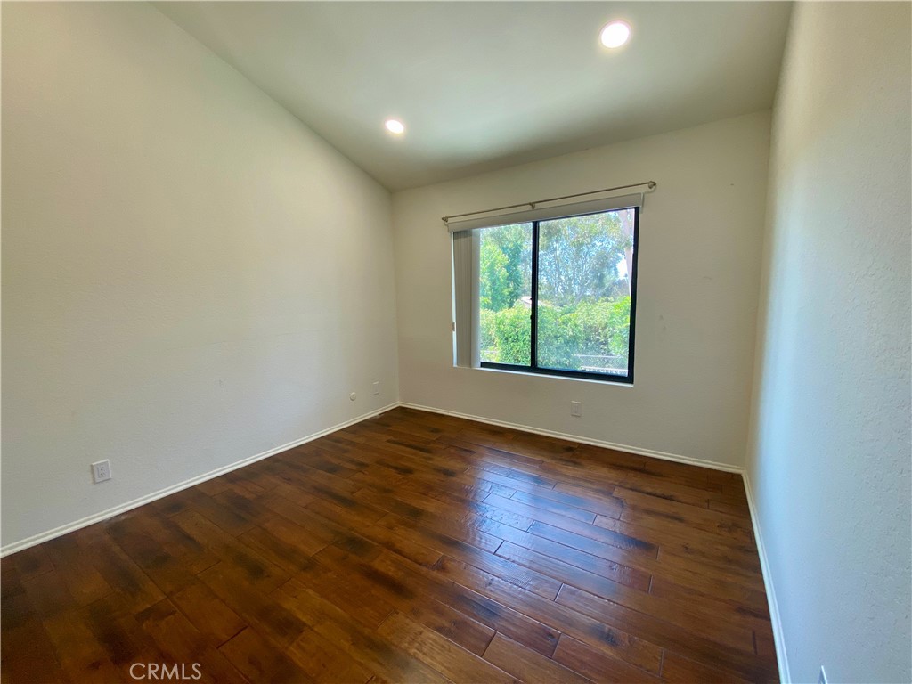 809 Creekside Drive, Unit 35 Fullerton, CA 92833 - Photo 19 of 23 an empty room with wooden floor and windows