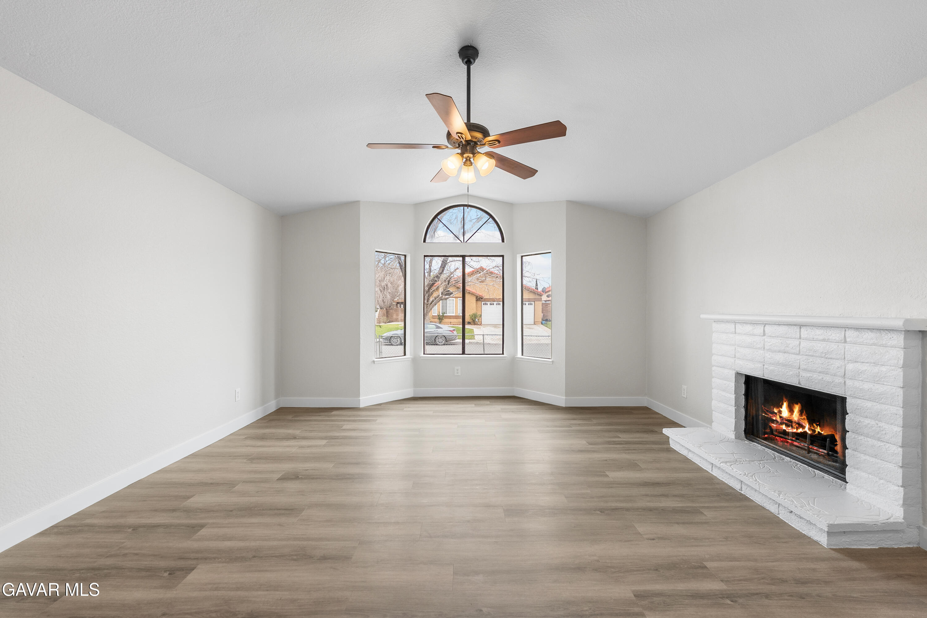 3563 Avenue R11 E Palmdale Ca East Palmdale, CA 93550 - Photo 11 of 37 a view of an empty room with a fireplace and a window