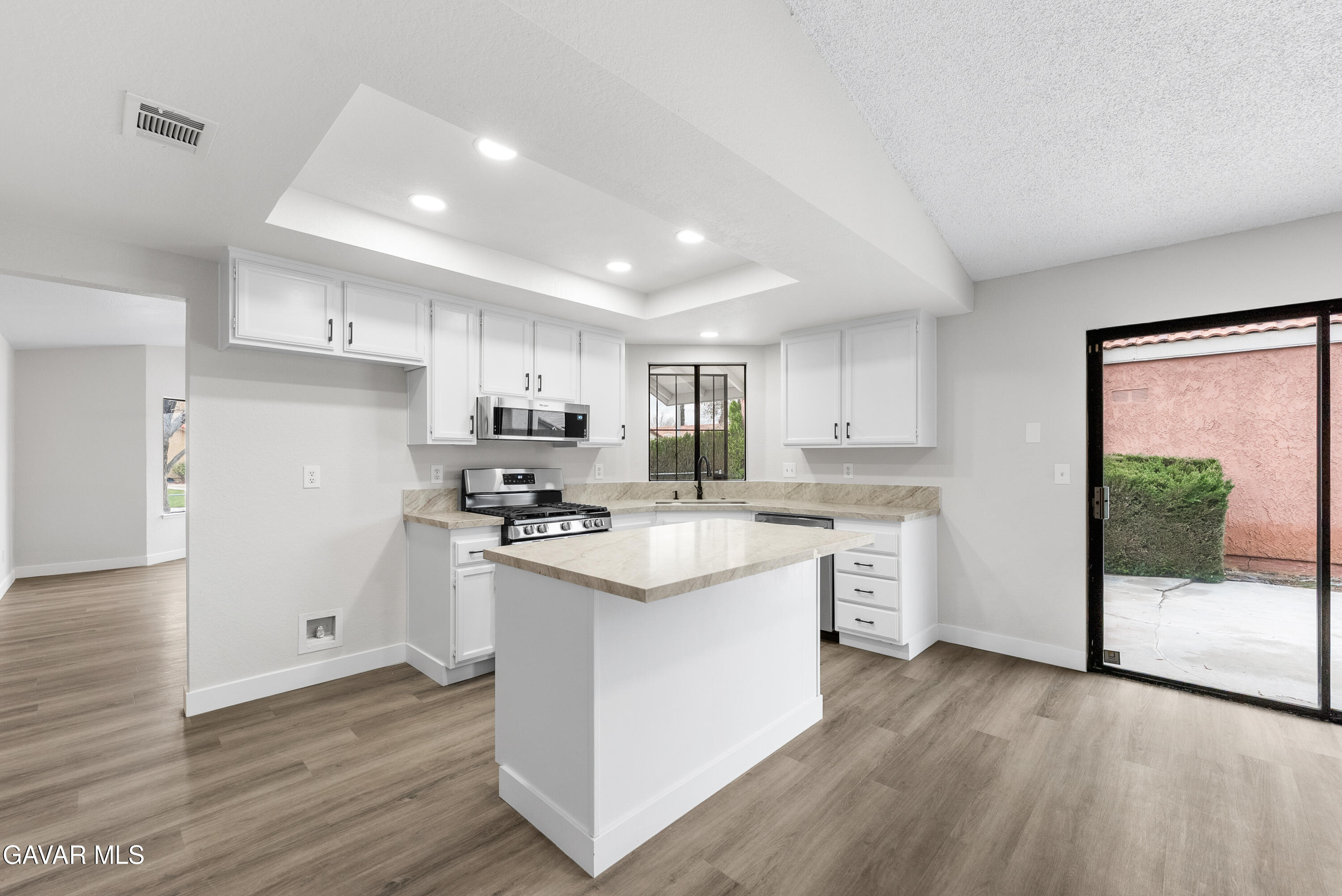 3563 Avenue R11 E Palmdale Ca East Palmdale, CA 93550 - Photo 13 of 37 a kitchen with stainless steel appliances granite countertop a refrigerator a sink dishwasher a stove and white countertops with wooden floor