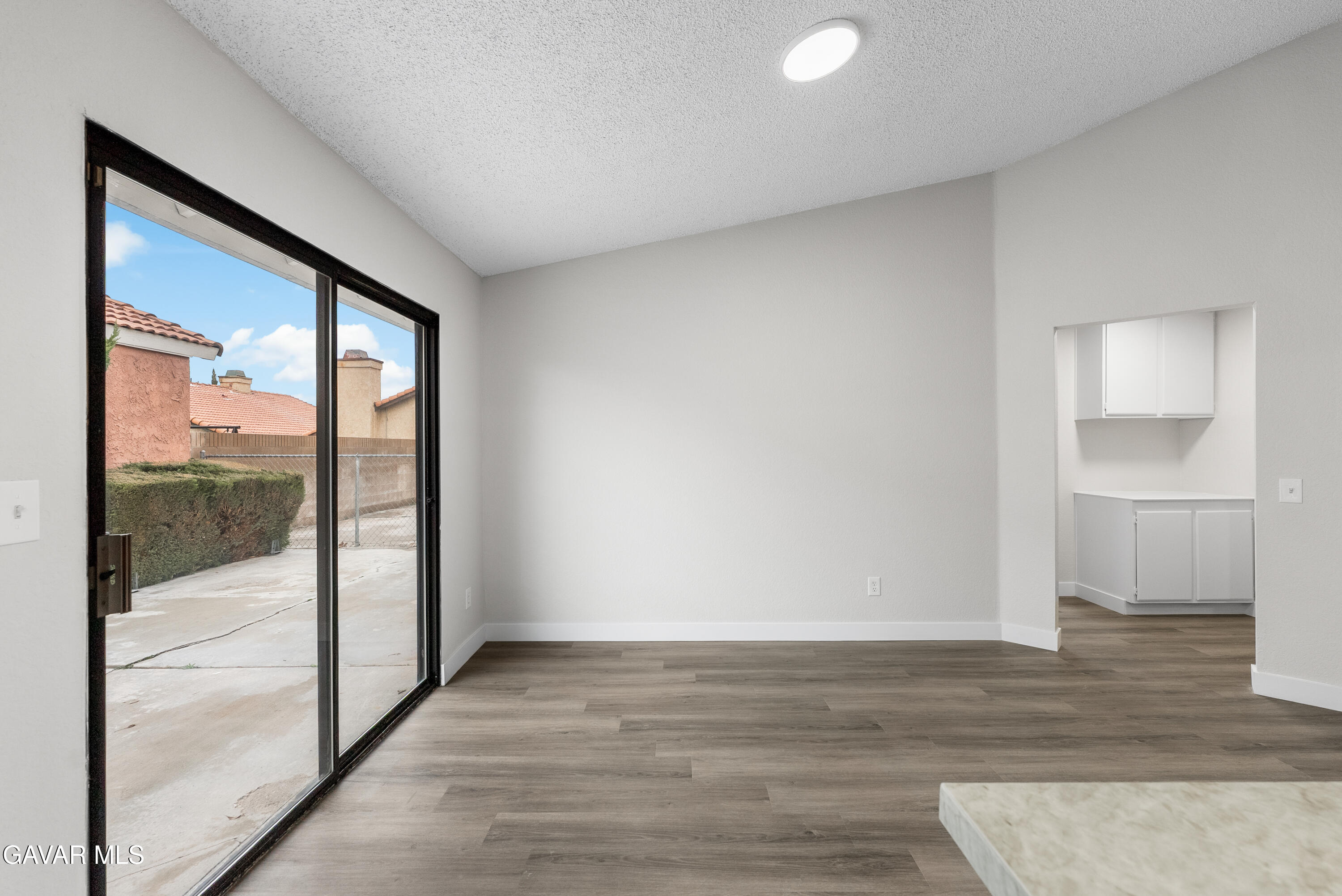 3563 Avenue R11 E Palmdale Ca East Palmdale, CA 93550 - Photo 17 of 37 a view of empty room with wooden floor and fan