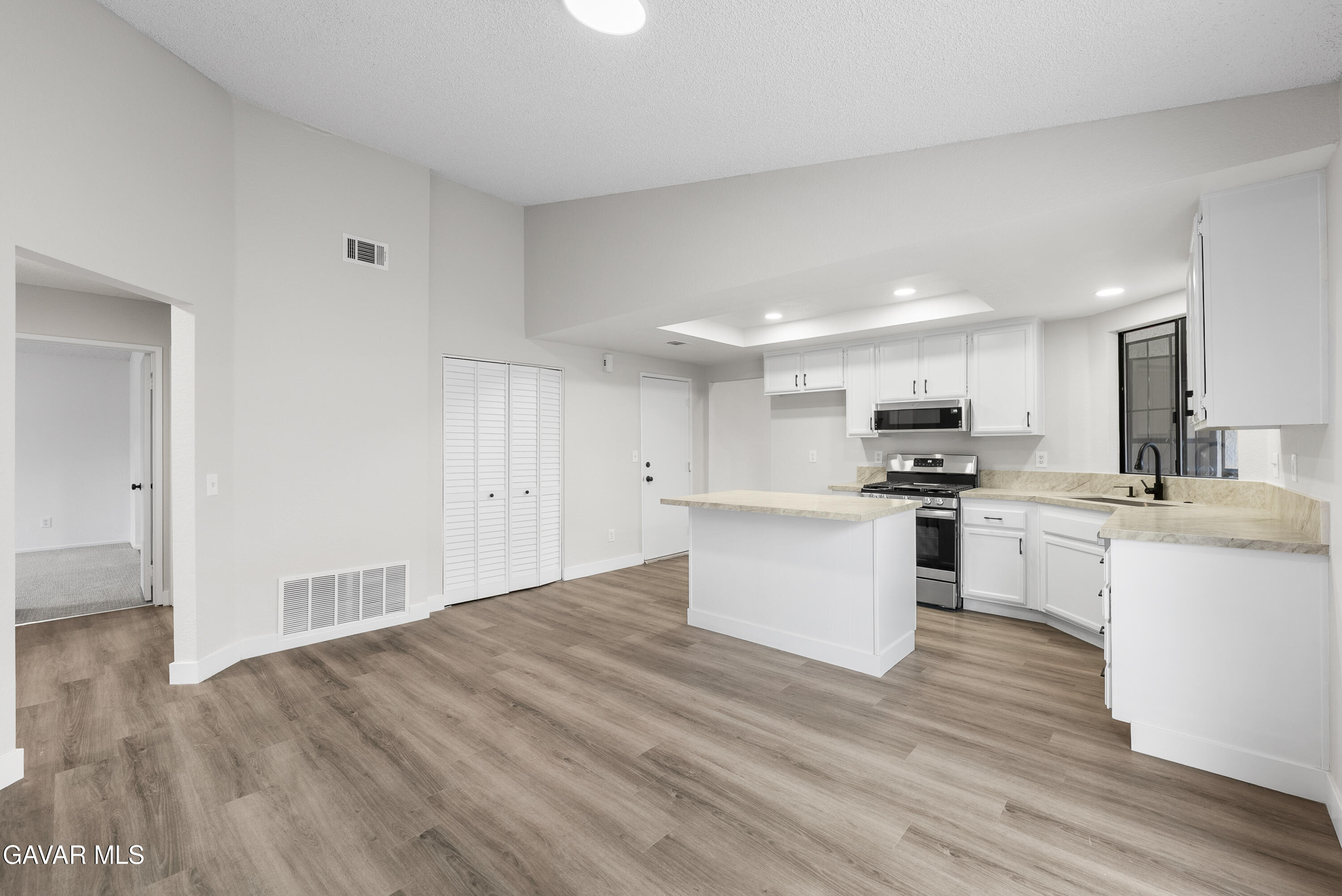 3563 Avenue R11 E Palmdale Ca East Palmdale, CA 93550 - Photo 18 of 37 a kitchen with granite countertop a sink cabinets and wooden floor