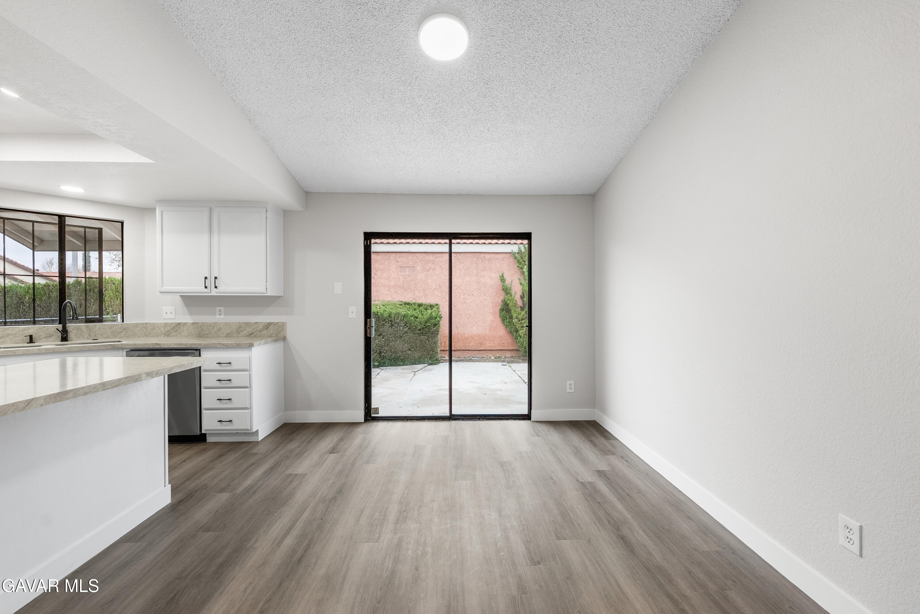 3563 Avenue R11 E Palmdale Ca East Palmdale, CA 93550 - Photo 21 of 37 a open kitchen with a large window a sink and white appliances