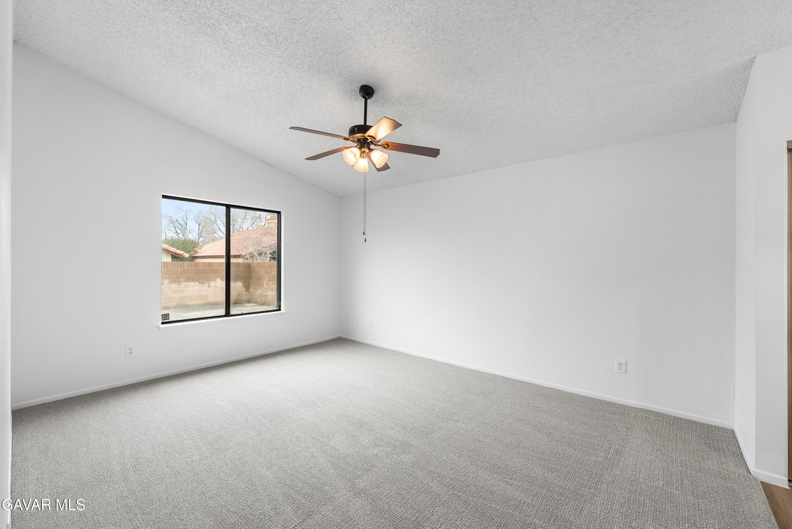 3563 Avenue R11 E Palmdale Ca East Palmdale, CA 93550 - Photo 22 of 37 an empty room with windows and chandelier fan