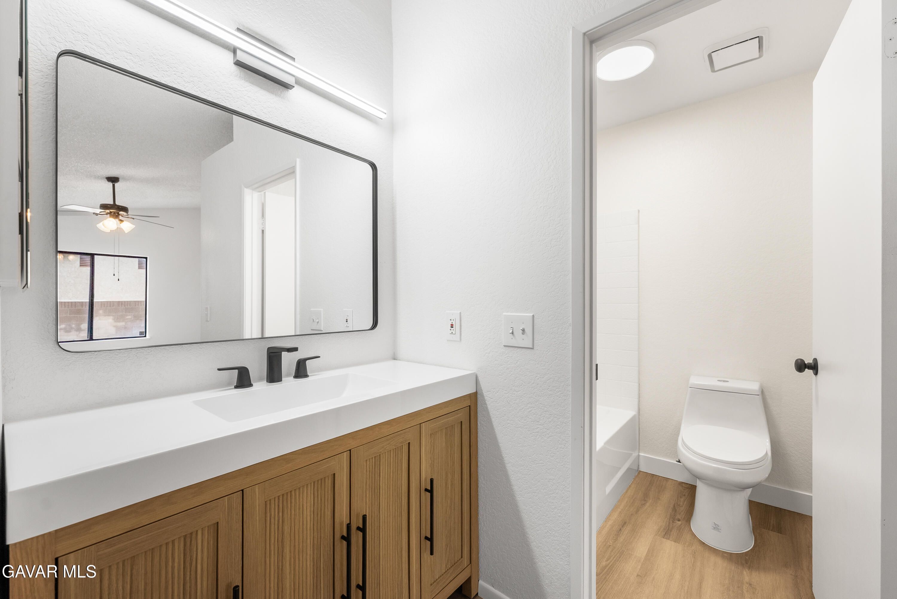 3563 Avenue R11 E Palmdale Ca East Palmdale, CA 93550 - Photo 26 of 37 a bathroom with a sink a toilet and a mirror