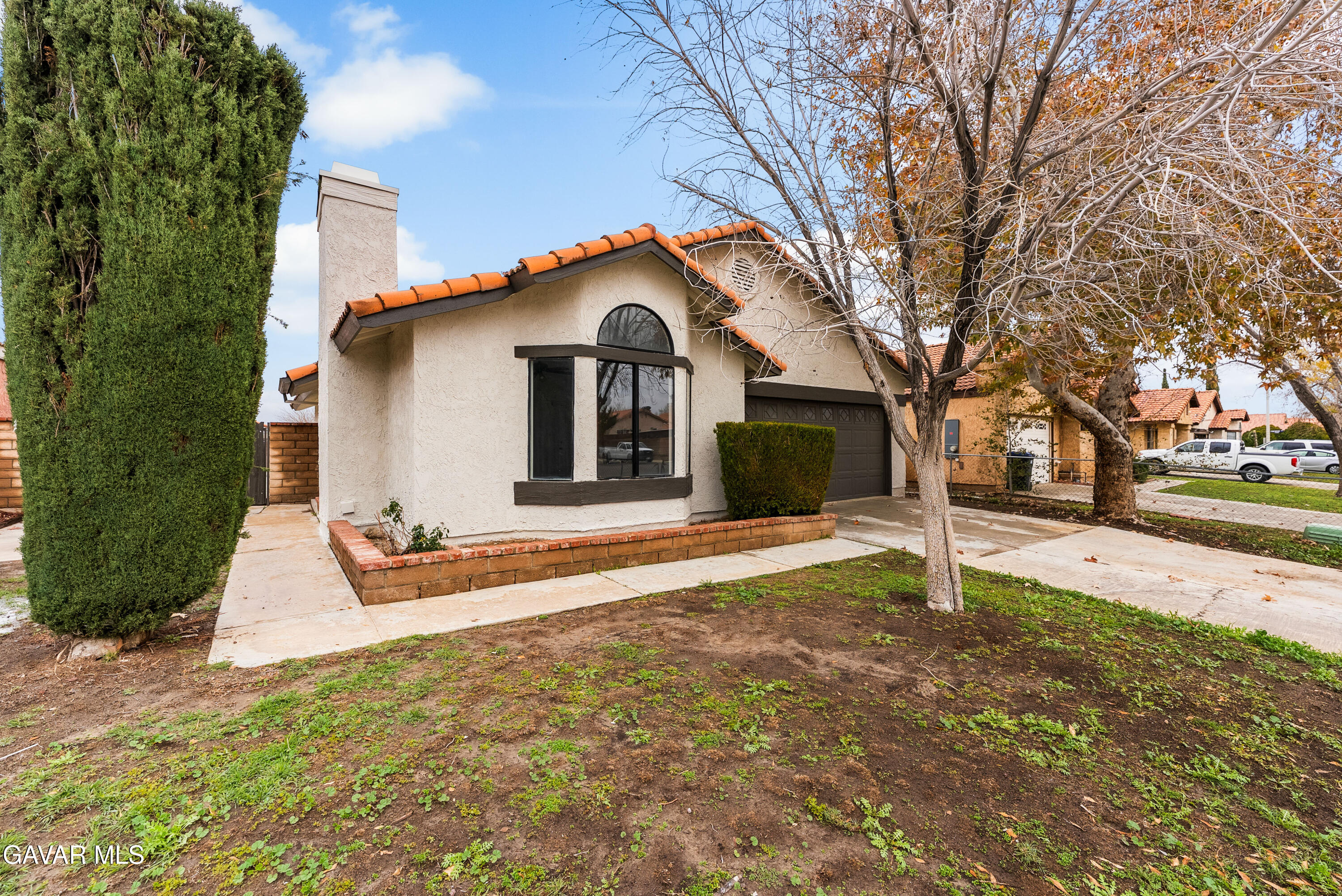 3563 Avenue R11 E Palmdale Ca East Palmdale, CA 93550 - Photo 5 of 37 a front view of a house with a yard and garage