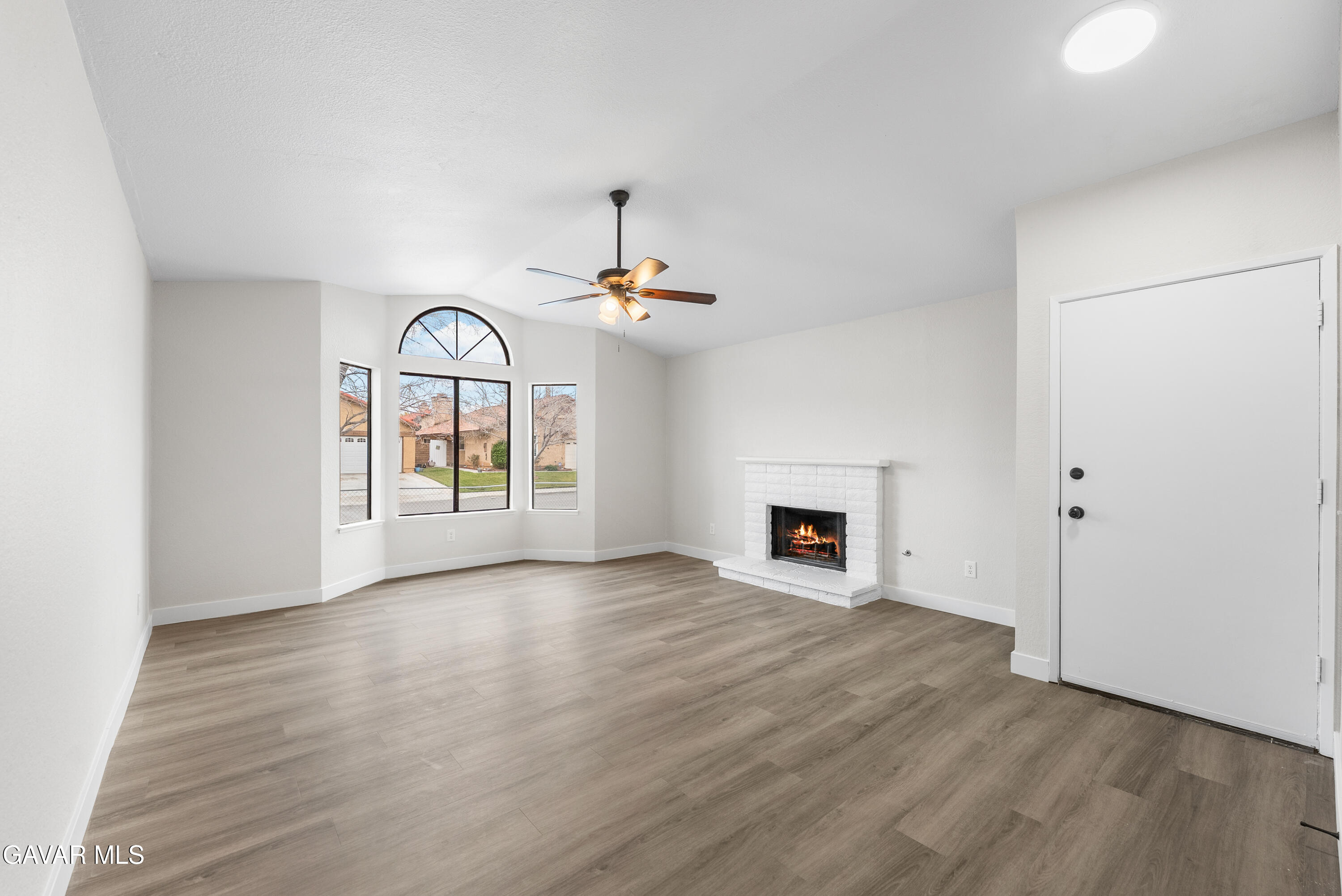 3563 Avenue R11 E Palmdale Ca East Palmdale, CA 93550 - Photo 8 of 37 an empty room with windows fireplace and fans